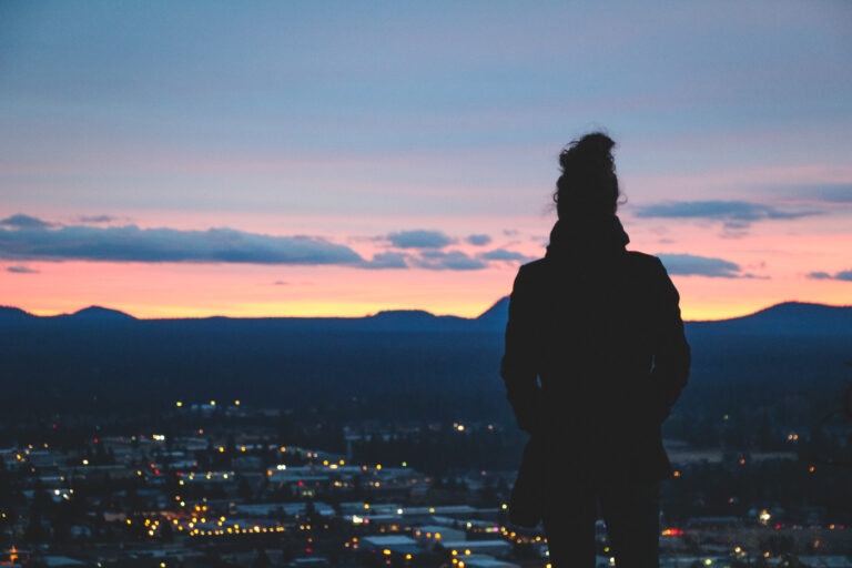Nina overlooking Bend from the Pilot Butte viewpoint during a sunset.