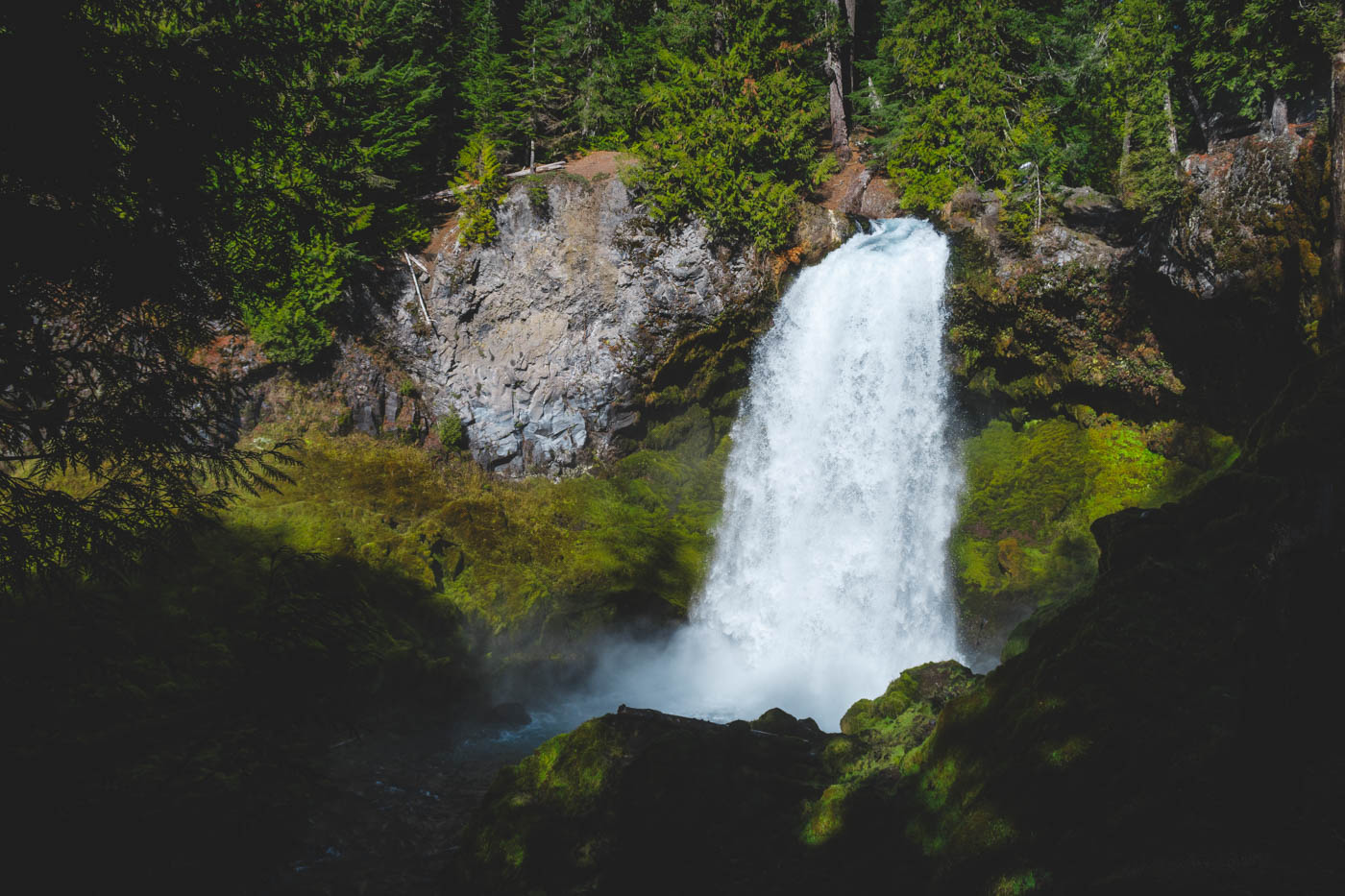 The huge Sahalie Falls flowing from a rock surrounded by the forests of Mt. Hood.