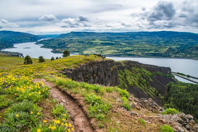 A trail leading down to the Coyote Wall rock formation with a view across Columbia River Gorge.