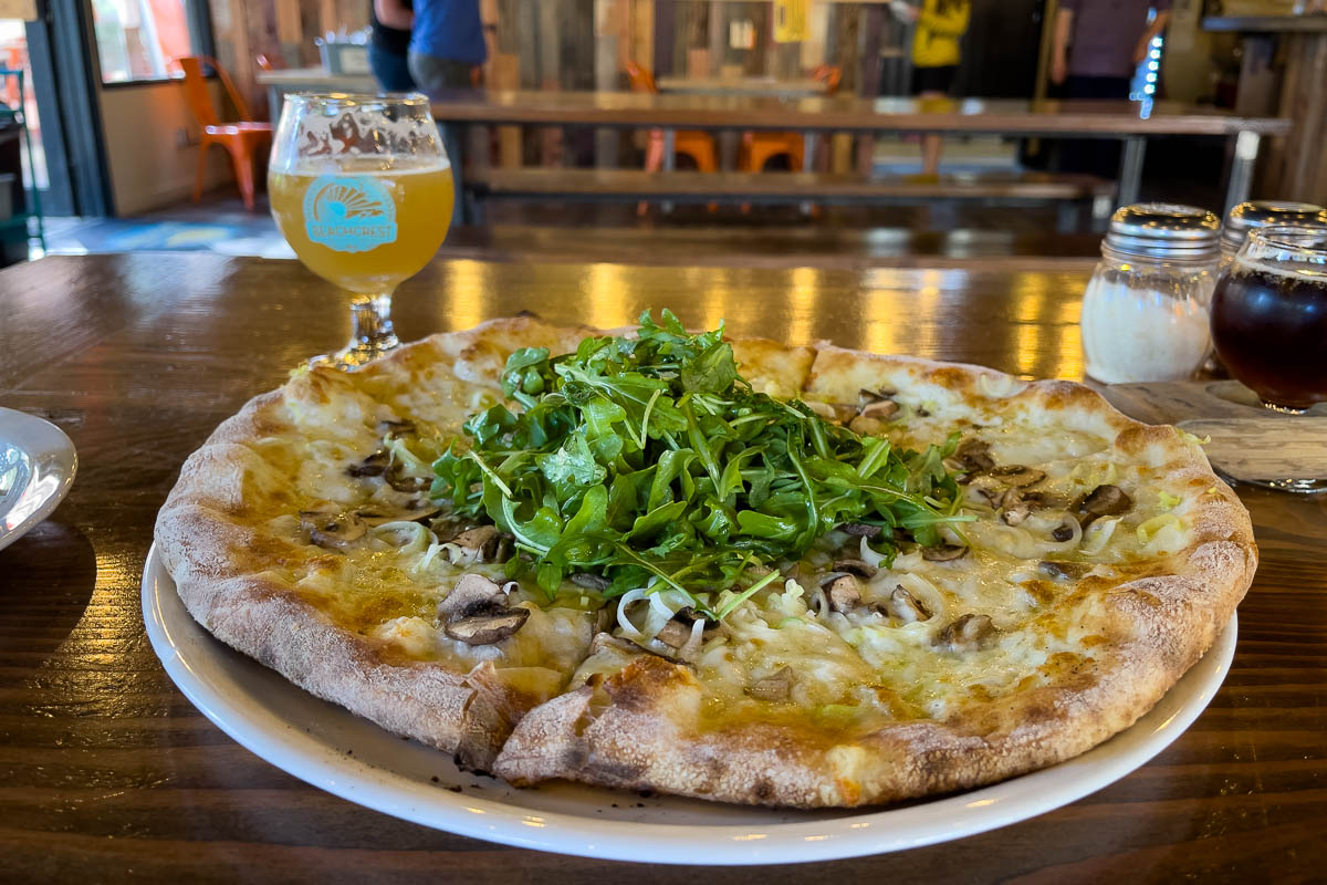 Beachcrest Brewing Company and pizza on table