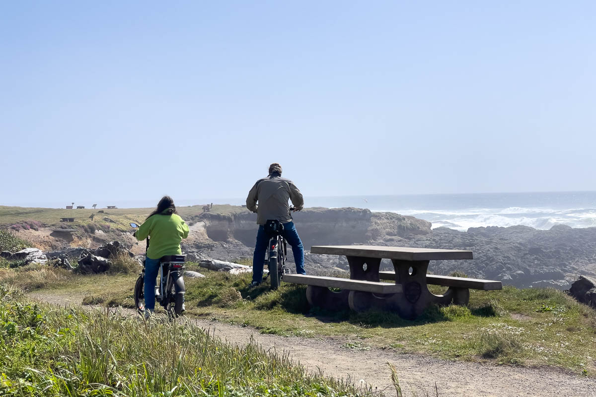 Smelt Sands State Recreation Site with two people on bikes on the coast.