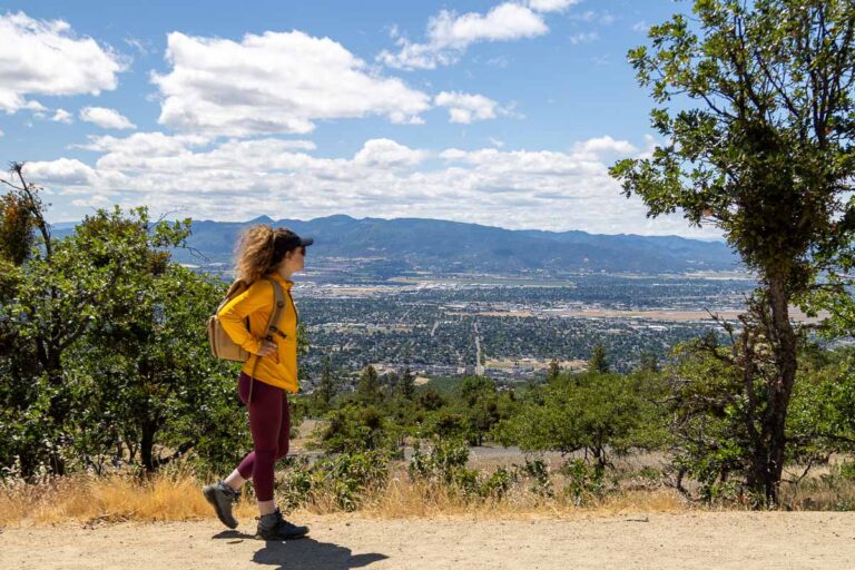 Nina walking a trail with Medford below.