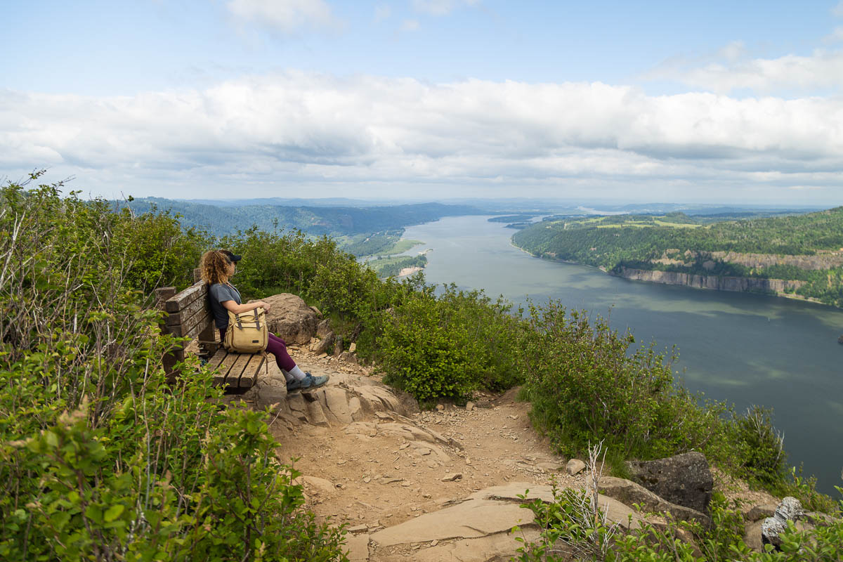 Angel's Rest Trail bench at summit, Nina sitting on it looking at the Gorge