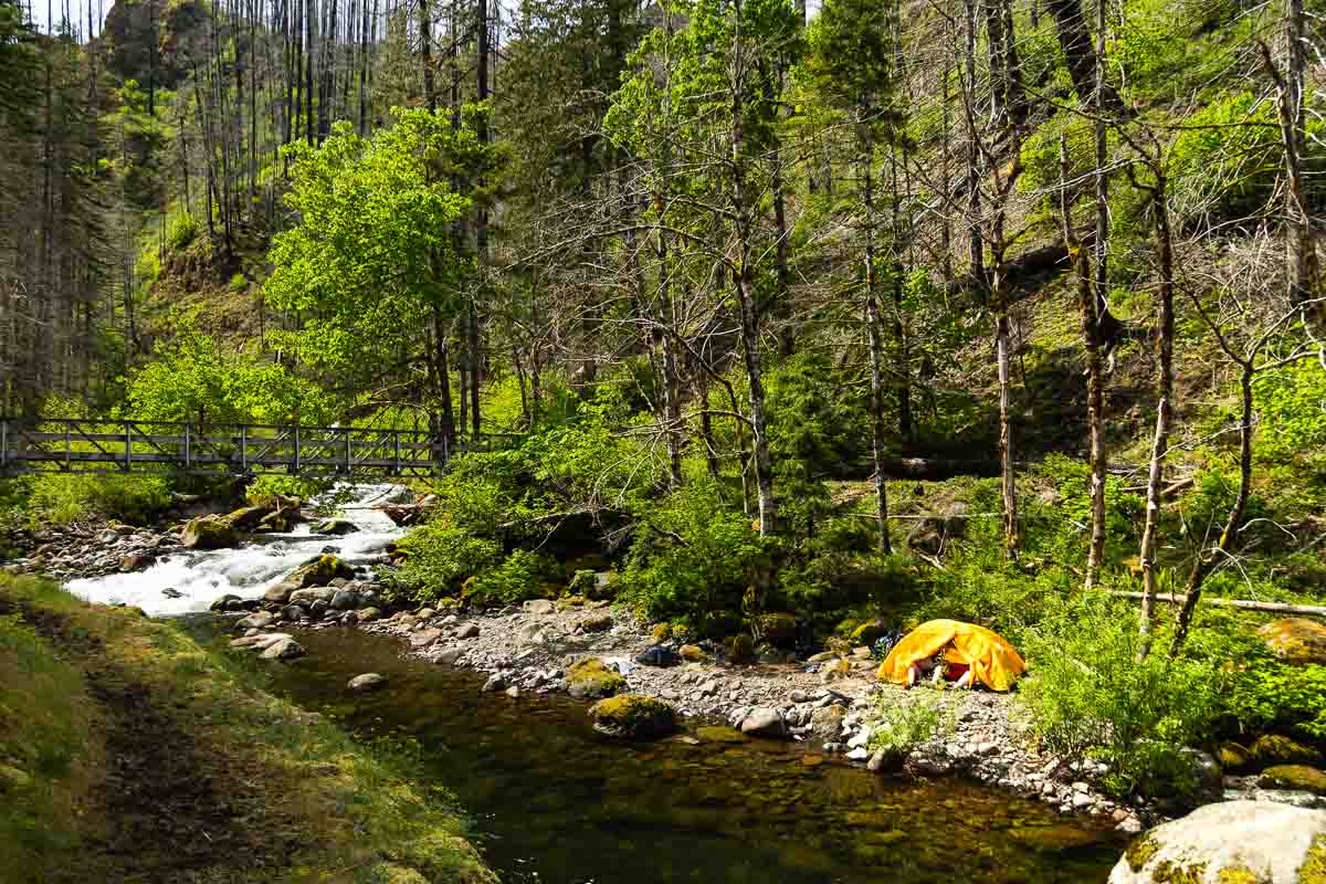 Four-mile bridge along river with yellow tent.