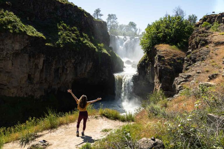 Nina posing with White River Falls in front of her.